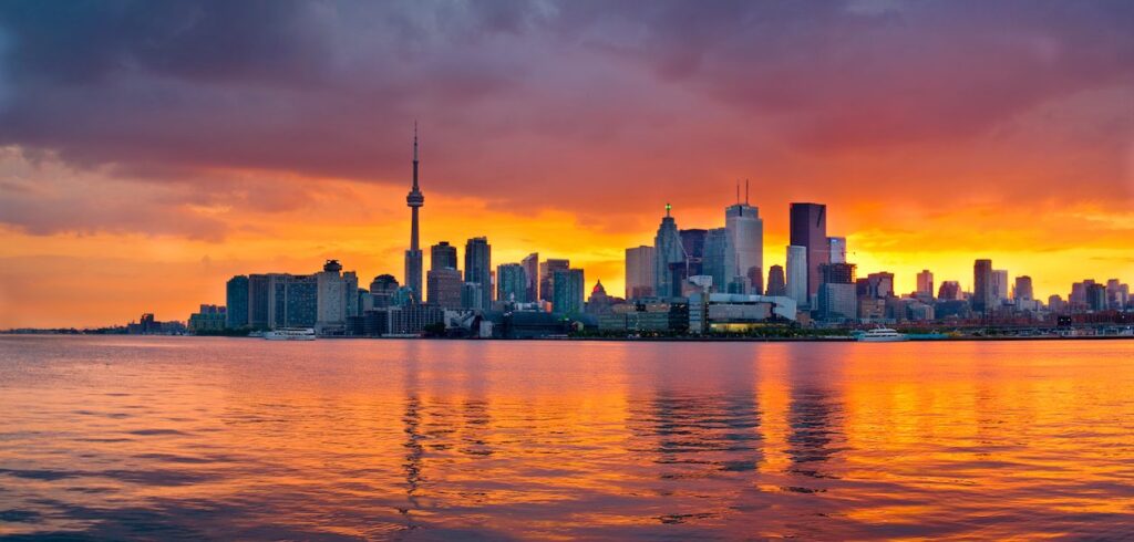Toronto skyline across the water at sunset
