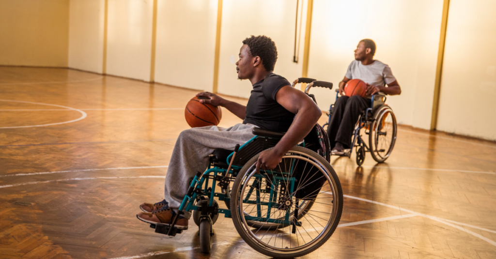 2 men in wheelchairs playing basketball.